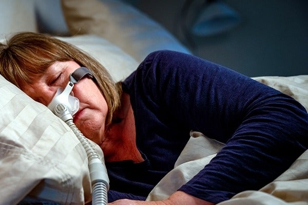 Woman using a CPAP machine
